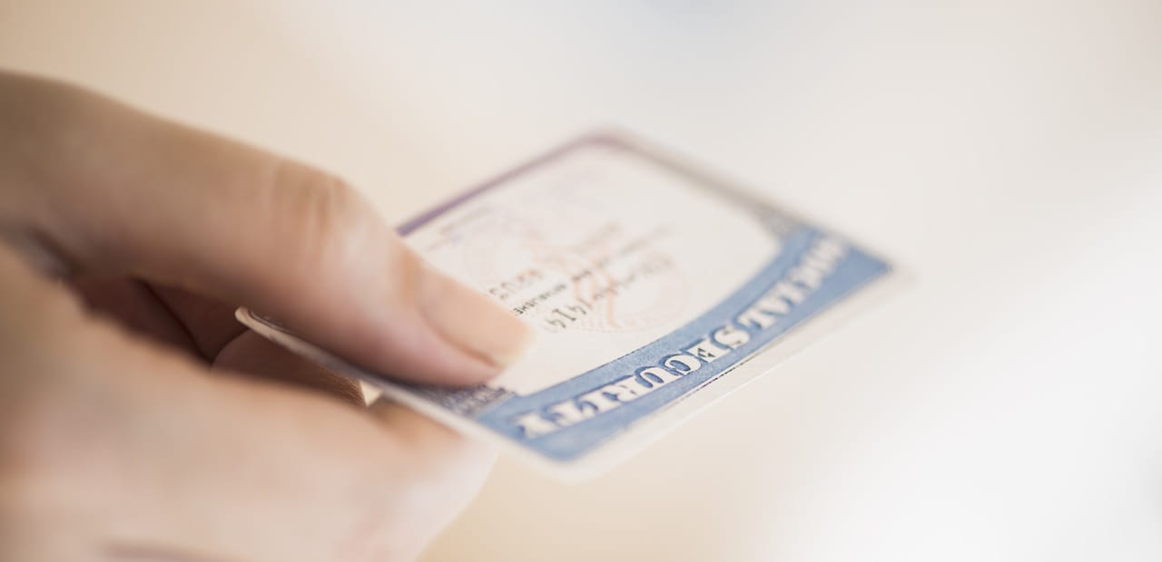 Close up of woman's hand holding social security card