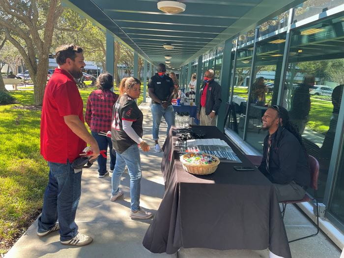 Associates chat with a United Way partner agency at the firm's United Way Day event