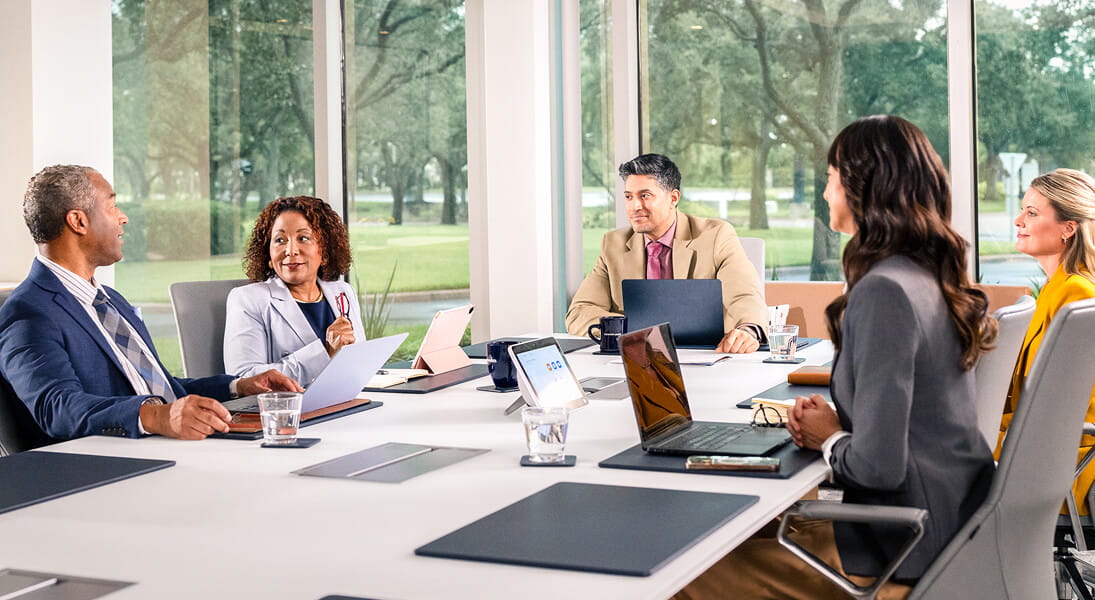 Experience professionals meeting in glass boardroom