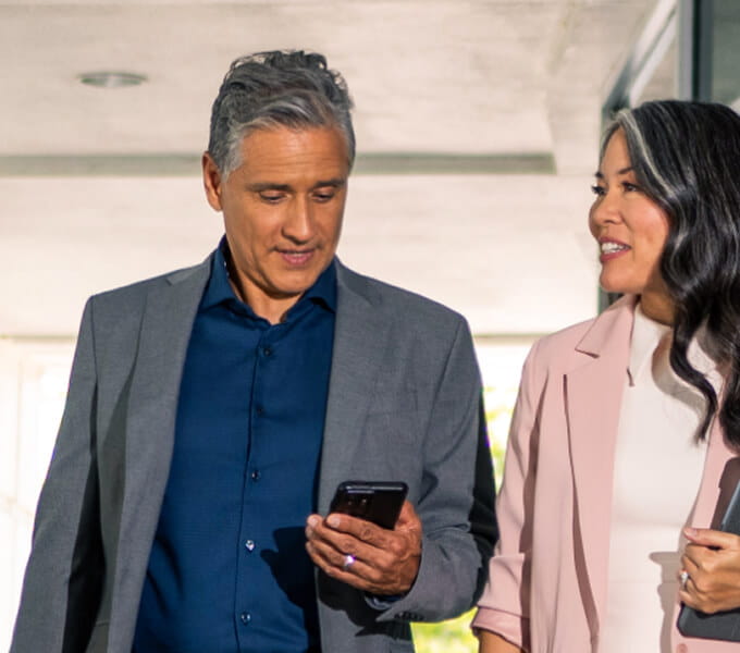 Two advisors discussing clients as they walk together