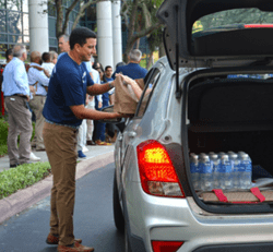 Paul Shoukry providing a hot meal kit at Raymond James event